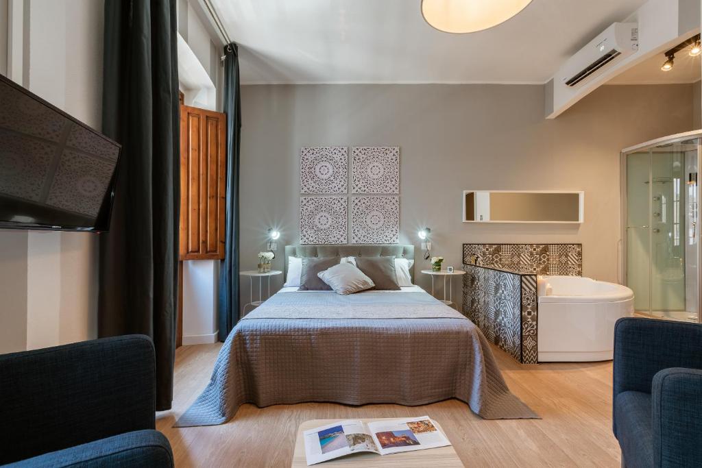 a bedroom with a bed and a tv in a room at Stampace Apartments in Cagliari