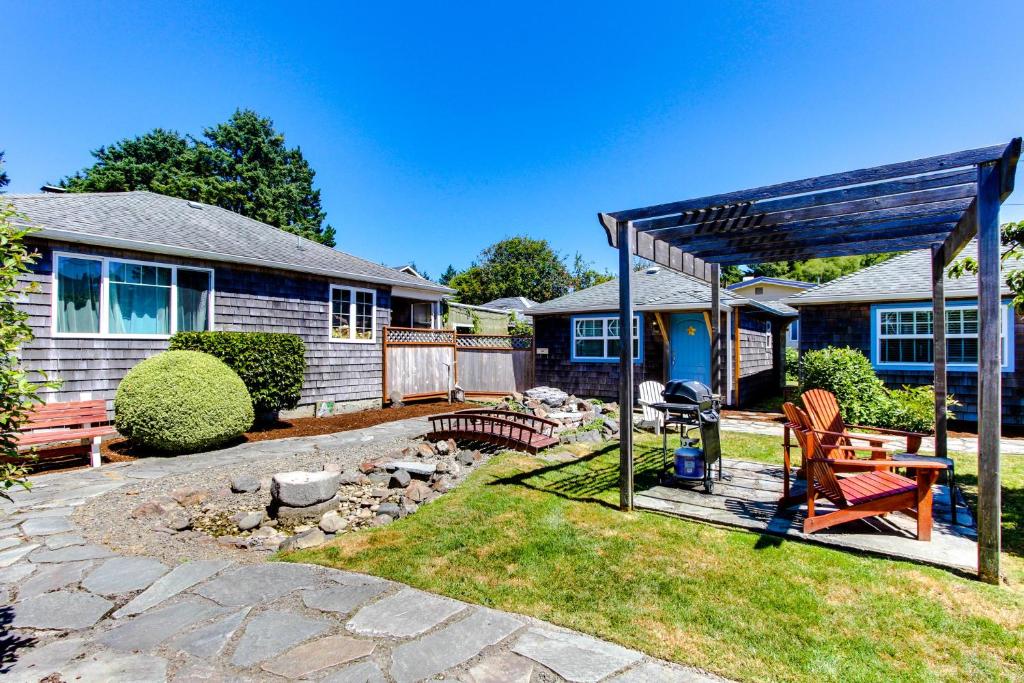 a backyard with a picnic table and a bench at Hidden Villa Cottages in Cannon Beach