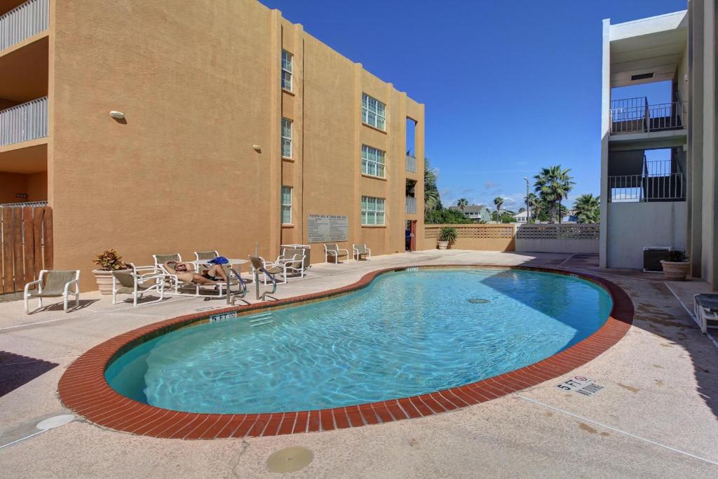 a swimming pool in front of a building at Fiesta Sol Condominiums in South Padre Island