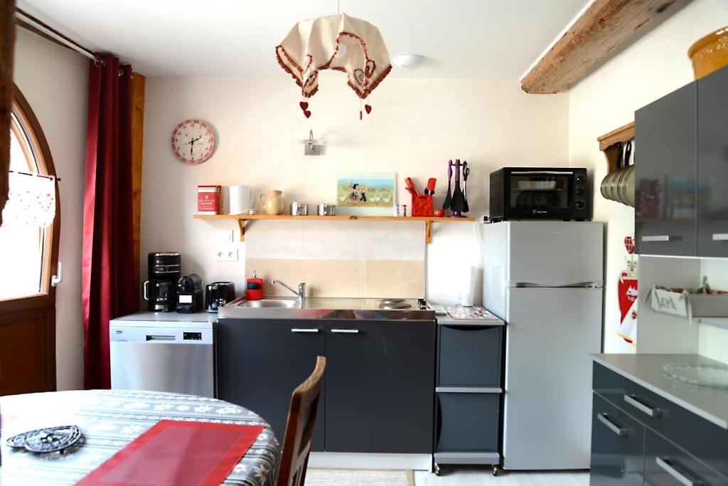 a small kitchen with a sink and a refrigerator at Le gîte de Gab in Eguisheim