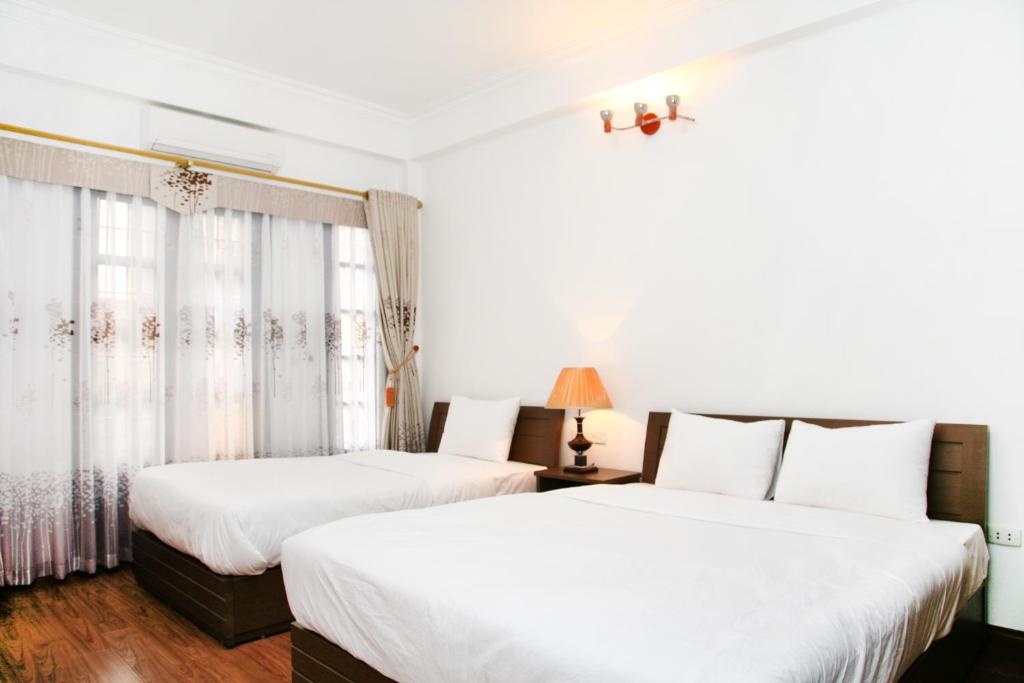 Postel nebo postele na pokoji v ubytování Bluebell Hotel
