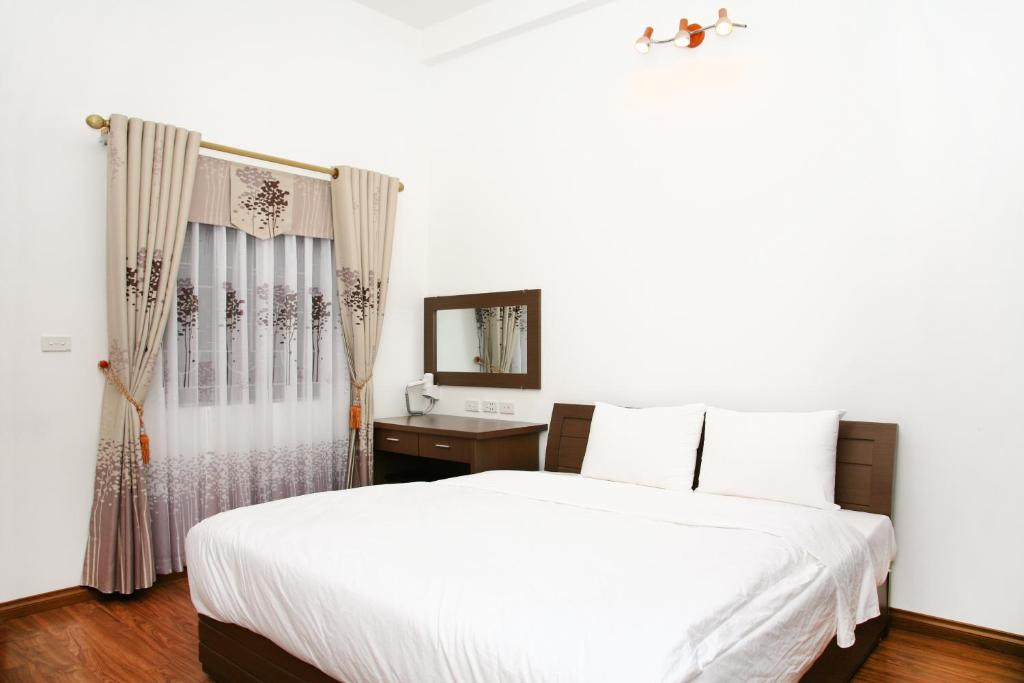 Postel nebo postele na pokoji v ubytování Bluebell Hotel