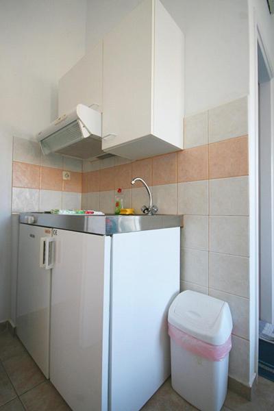 a small kitchen with a sink and a toilet at Anna Studios in Katapola
