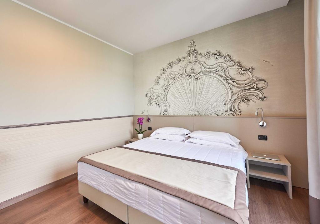 Postel nebo postele na pokoji v ubytování Hotel Corallo