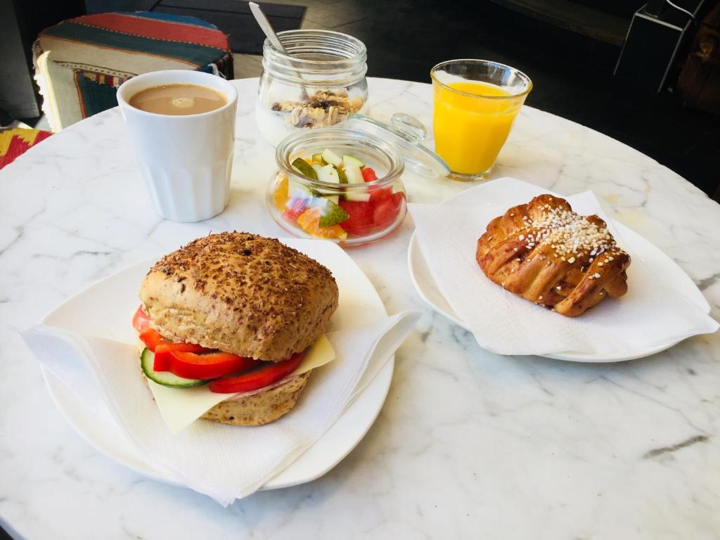 a table with two plates of food and a sandwich at City Backpackers Hostel in Stockholm