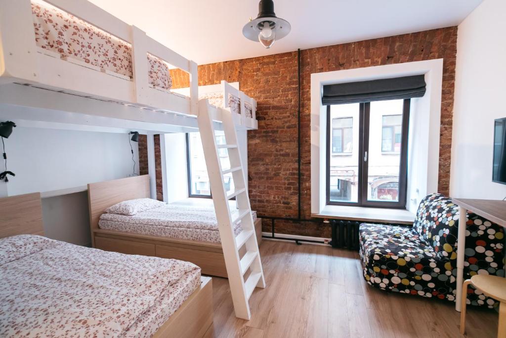 a bedroom with two bunk beds and a window at Bigland House in Saint Petersburg
