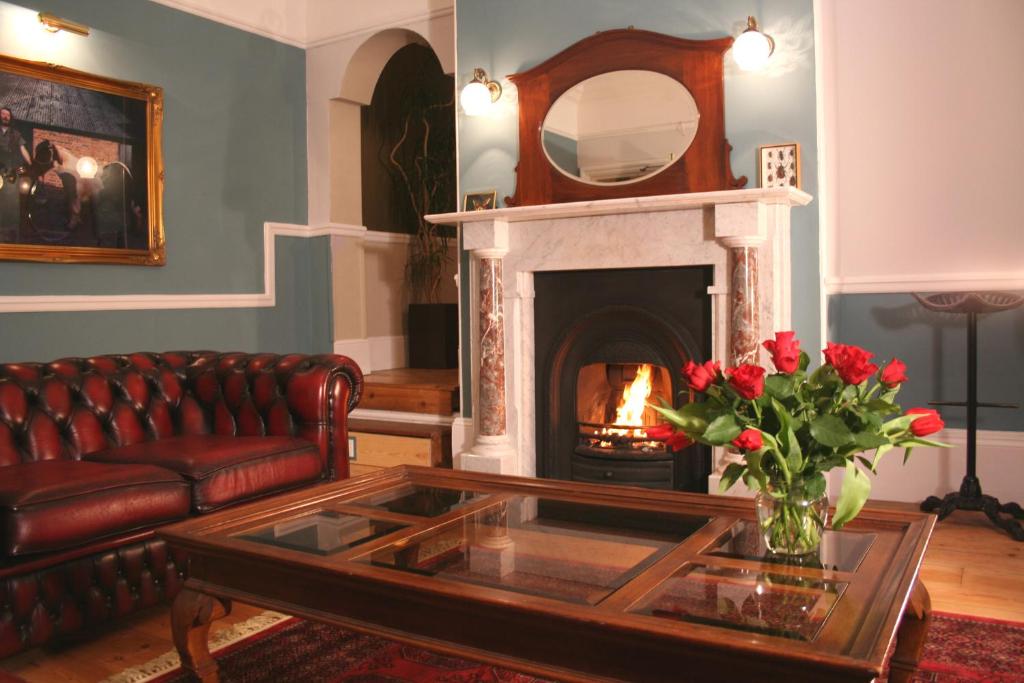 a living room with a couch and a fireplace at The Telstar in Exeter