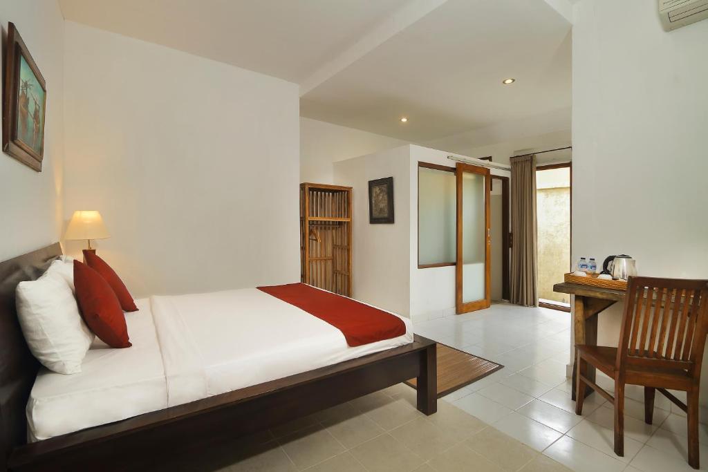 Postel nebo postele na pokoji v ubytování Manggis Sari Guesthouse
