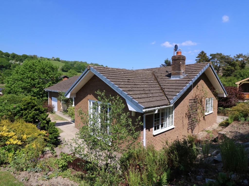 a brick house with ivy growing on it at Pen Y Maes in Builth Wells