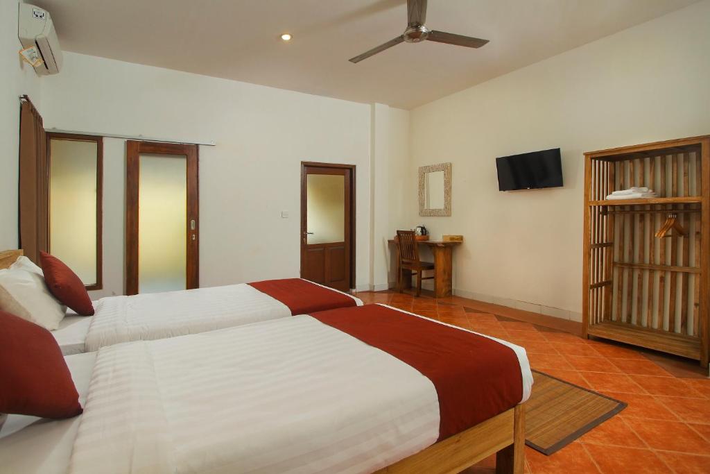 Postel nebo postele na pokoji v ubytování Manggis Sari Guesthouse