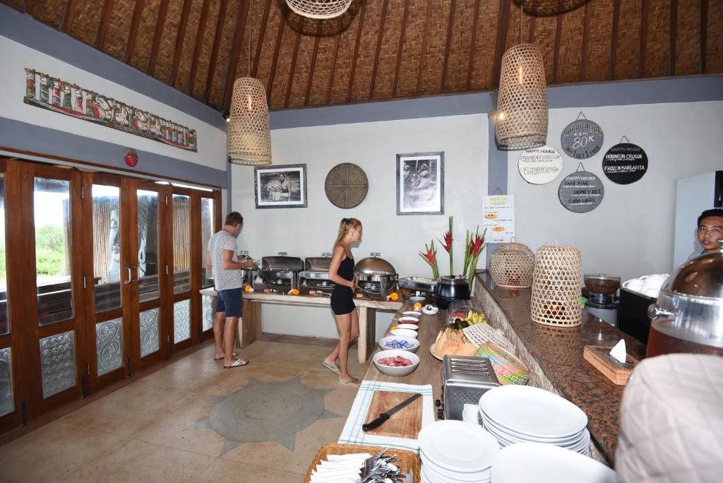 a group of people standing in a kitchen at Dream Beach Huts in Nusa Lembongan