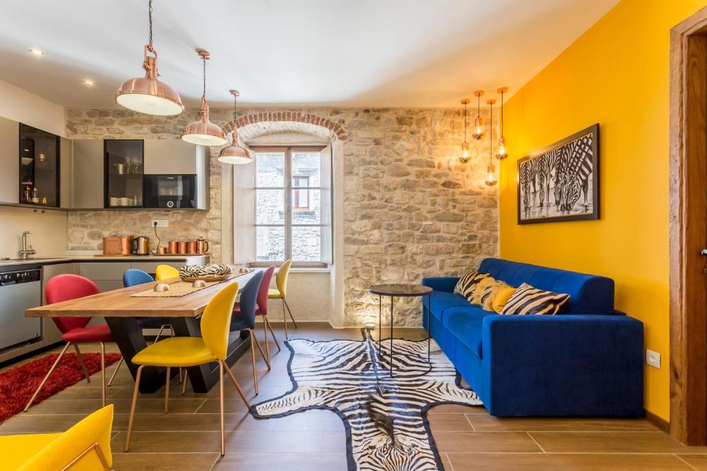 a living room with a blue couch and a table at byGRACE Apartment in Split