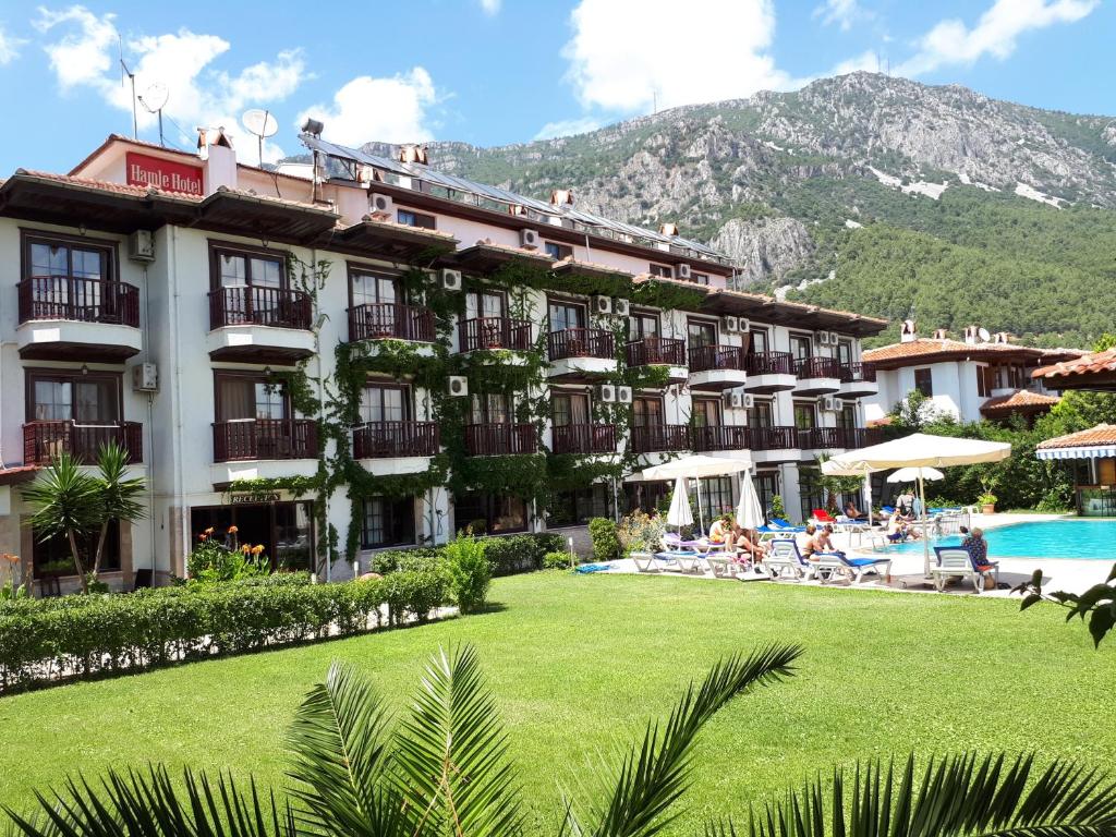 a hotel with a large yard and a swimming pool at Hamle Hotel in Akyaka