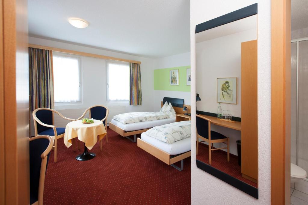 Postel nebo postele na pokoji v ubytování Hotel Arkanum