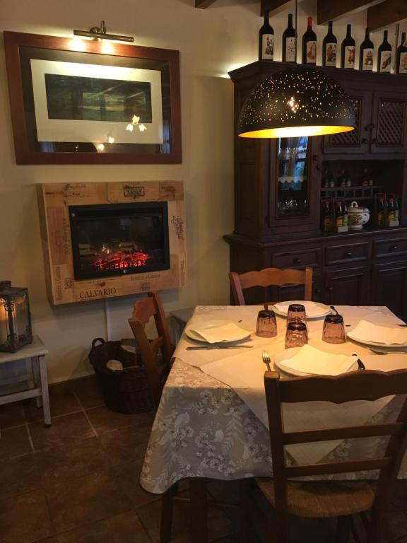 a dining room with a table and a tv at La Posada de Barro in Infiesto