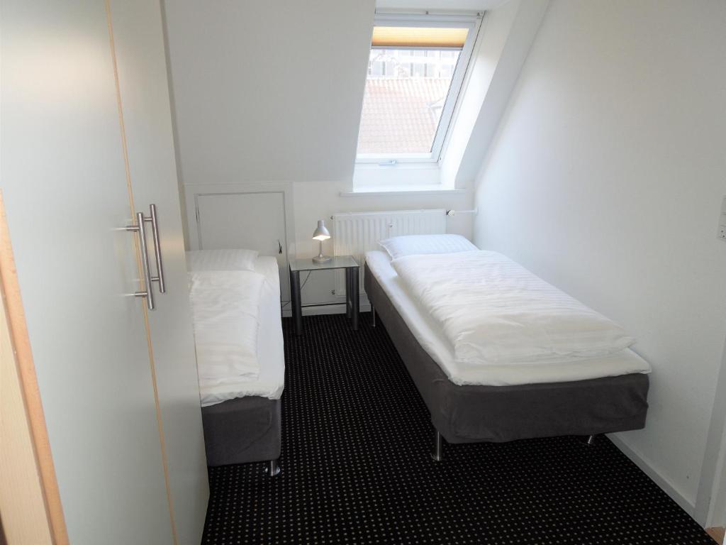 Postel nebo postele na pokoji v ubytování Hotel Aarhus City Apartments