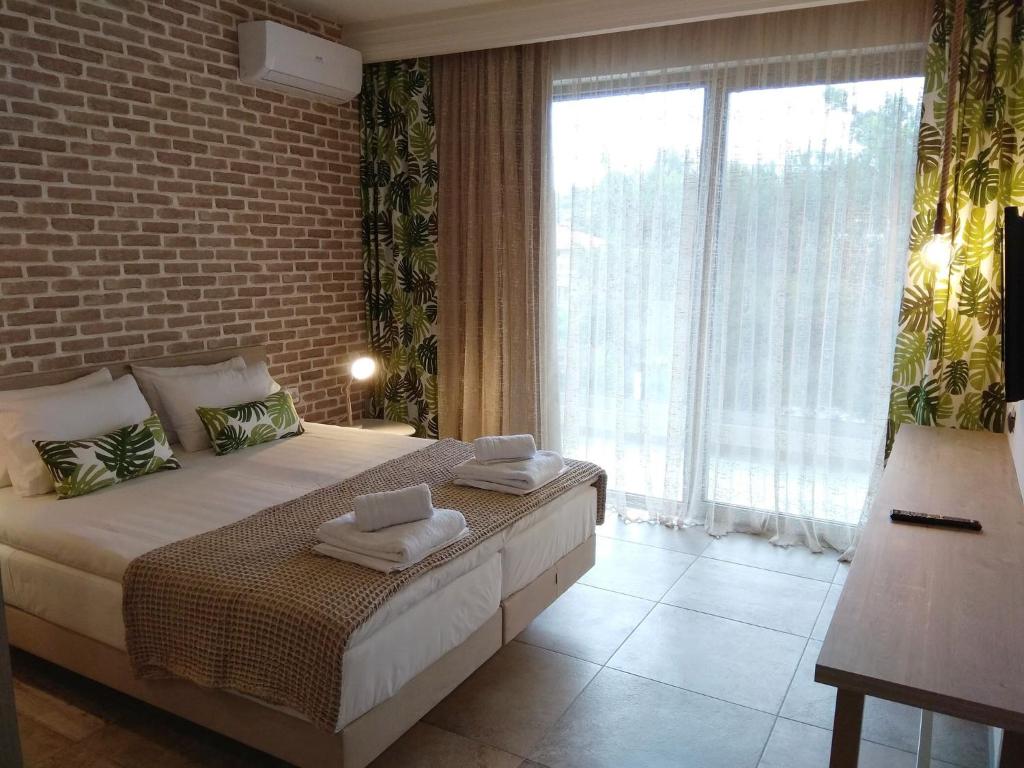 a bedroom with a bed and a large window at The Archontariki in Ormos Panagias