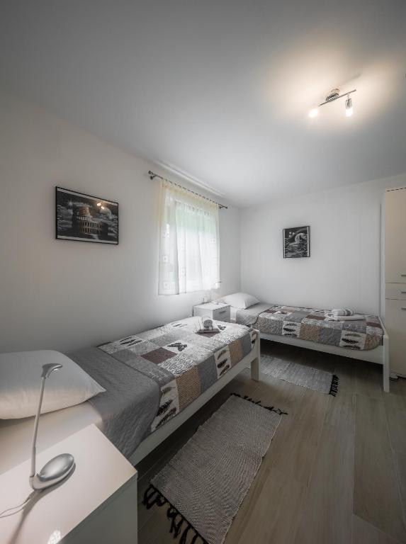 Postel nebo postele na pokoji v ubytování Plitvice Family Apartment