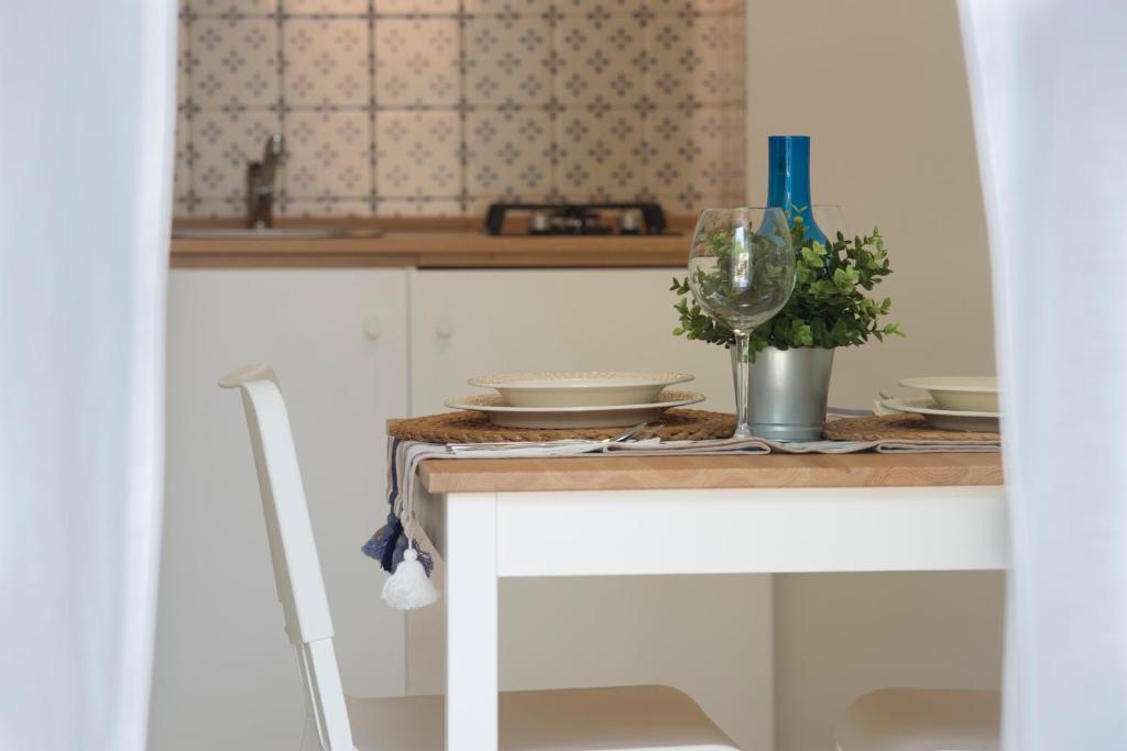 una cocina con una mesa con platos y una copa en Holiday House D' Anna 68 en Agerola