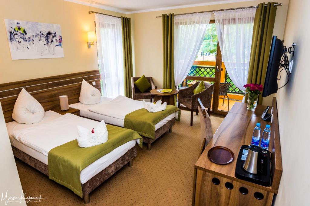 Postel nebo postele na pokoji v ubytování Hotel Na Skarpie