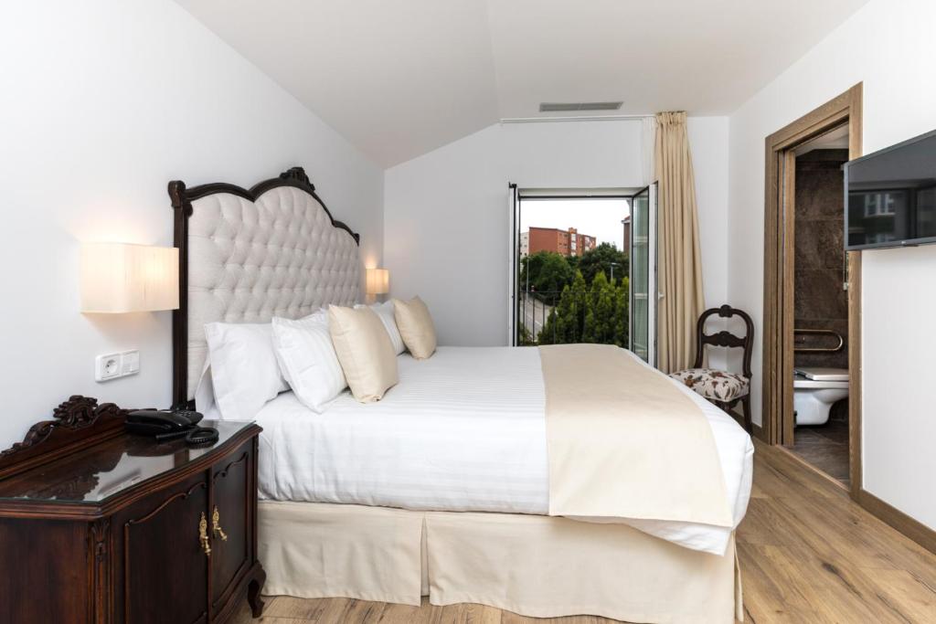 Rúm í herbergi á Suite Home Pinares