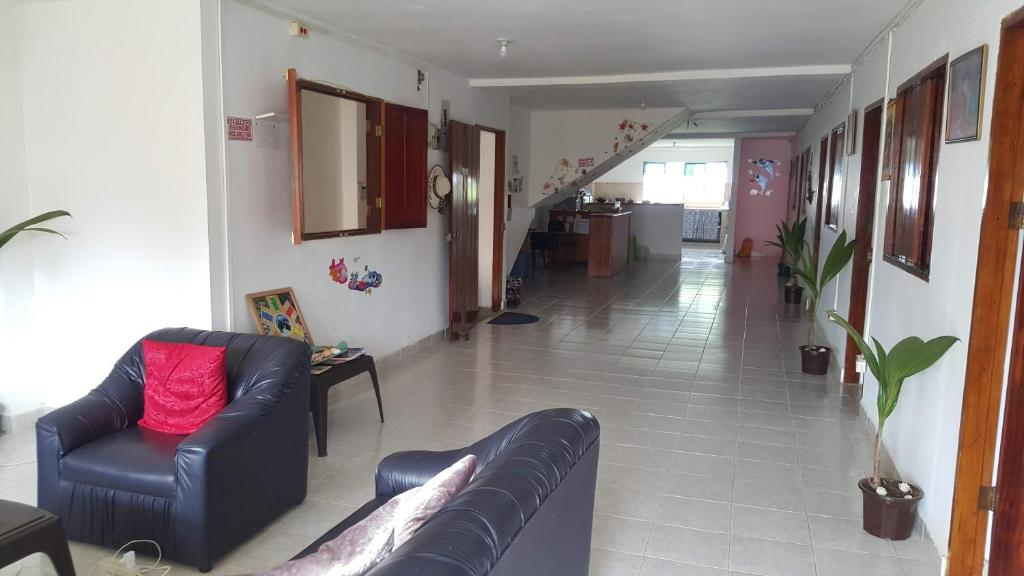 a living room with two couches and a hallway at Alojamiento in Bahía Solano