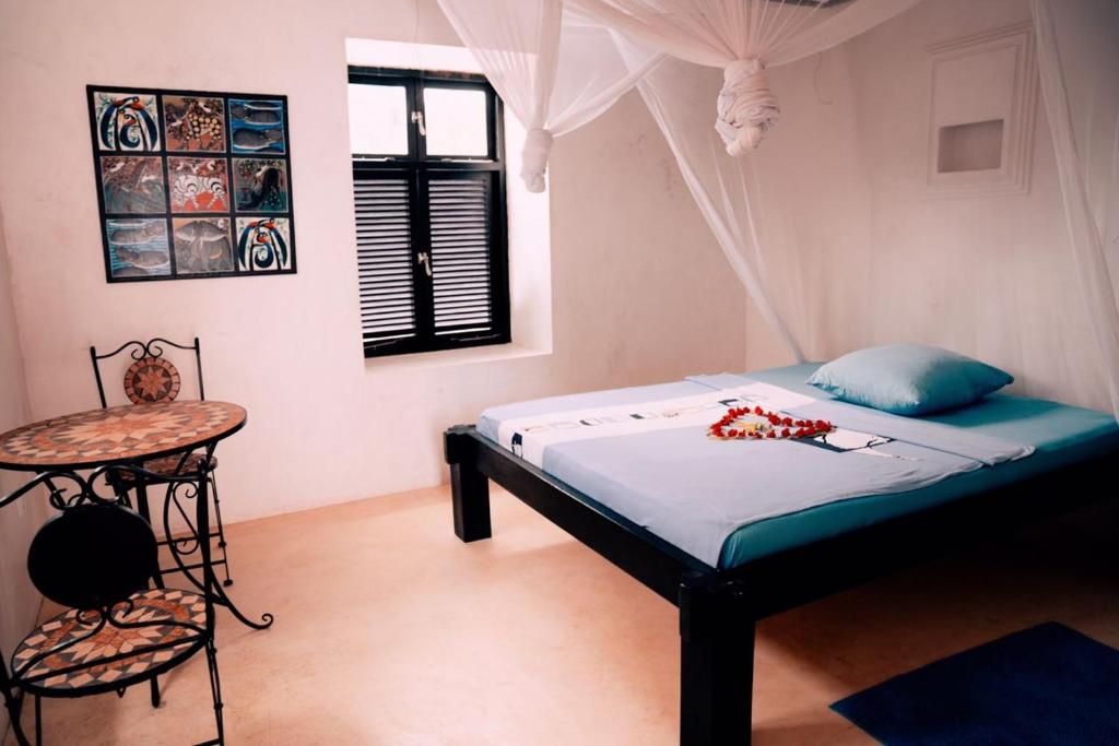 Tempat tidur dalam kamar di Jamala Guesthouse