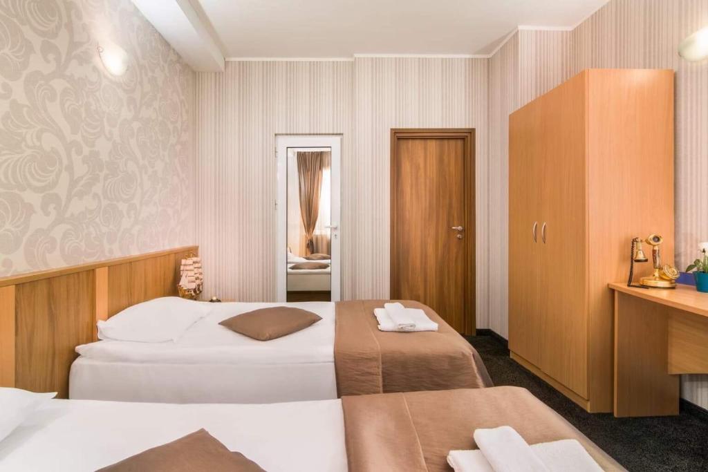 Postel nebo postele na pokoji v ubytování Hotel Central Point