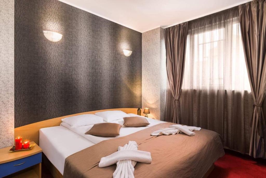 Postel nebo postele na pokoji v ubytování Hotel Central Point