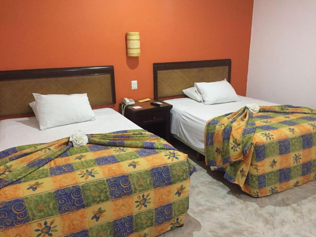 Postel nebo postele na pokoji v ubytování Hotel María Jose