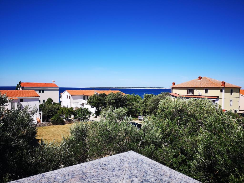 a view of some buildings with the ocean in the background at Apartments Milena 8 in Mandre