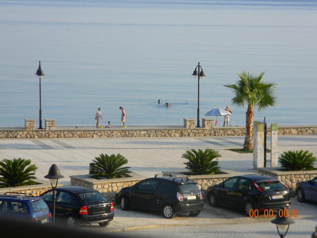 a group of cars parked next to the beach at Villa Kostandin in Qeparo