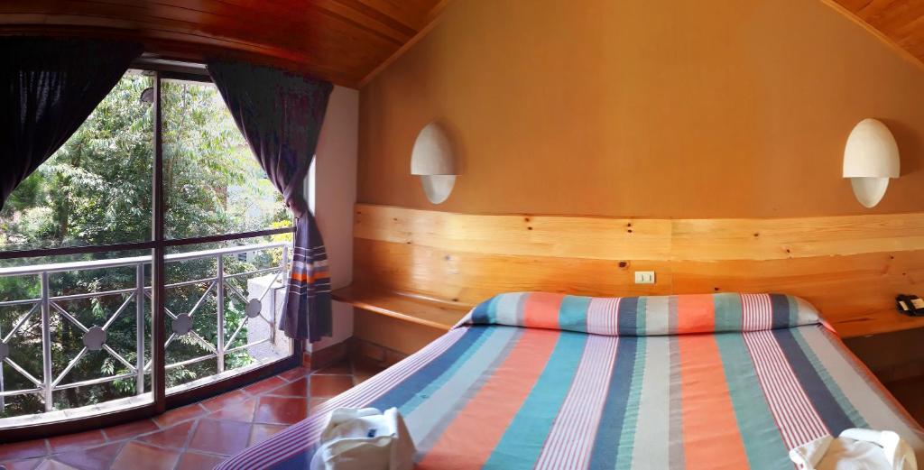 Postel nebo postele na pokoji v ubytování Axkan Arte Hotel