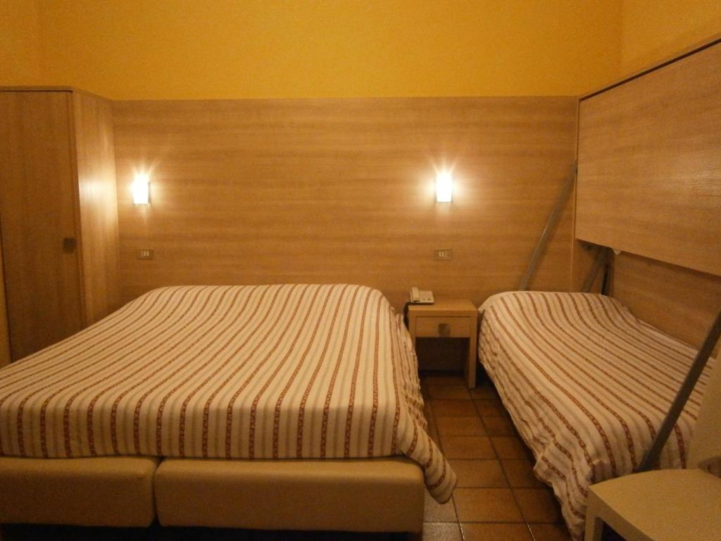 Postel nebo postele na pokoji v ubytování Hotel Chiara