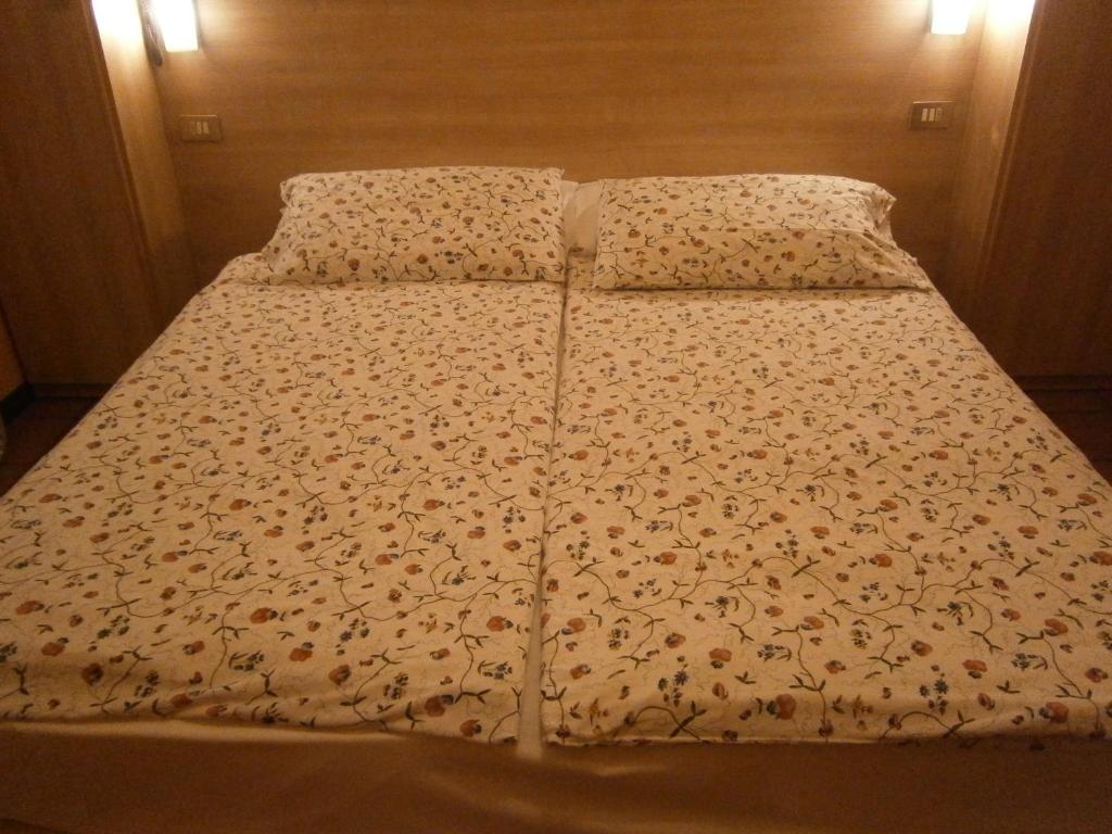 Postel nebo postele na pokoji v ubytování Hotel Chiara