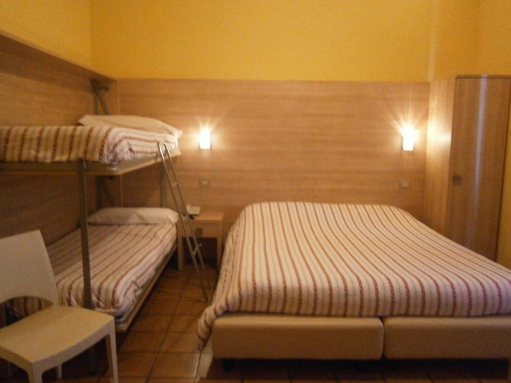 Postel nebo postele na pokoji v ubytování Hotel Chiara