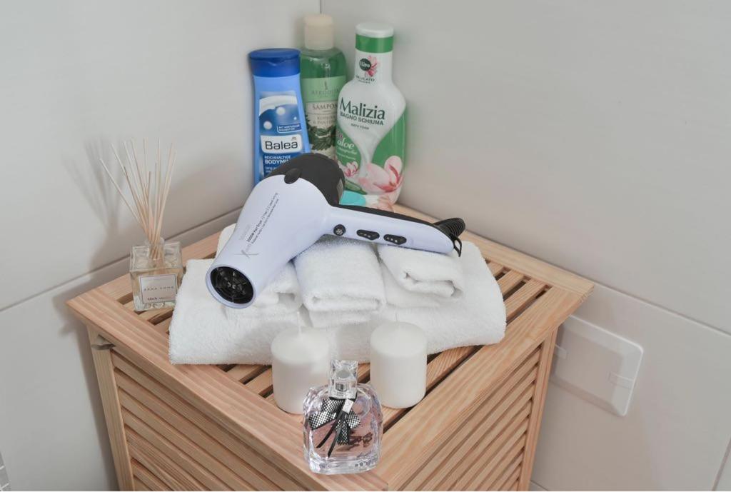 a shelf with towels and other bathroom items on it at Lux Apartman Daria in Zlatibor