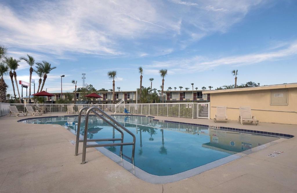 a swimming pool with a slide in a resort at Extended Stay - Ormond Beach in Ormond Beach