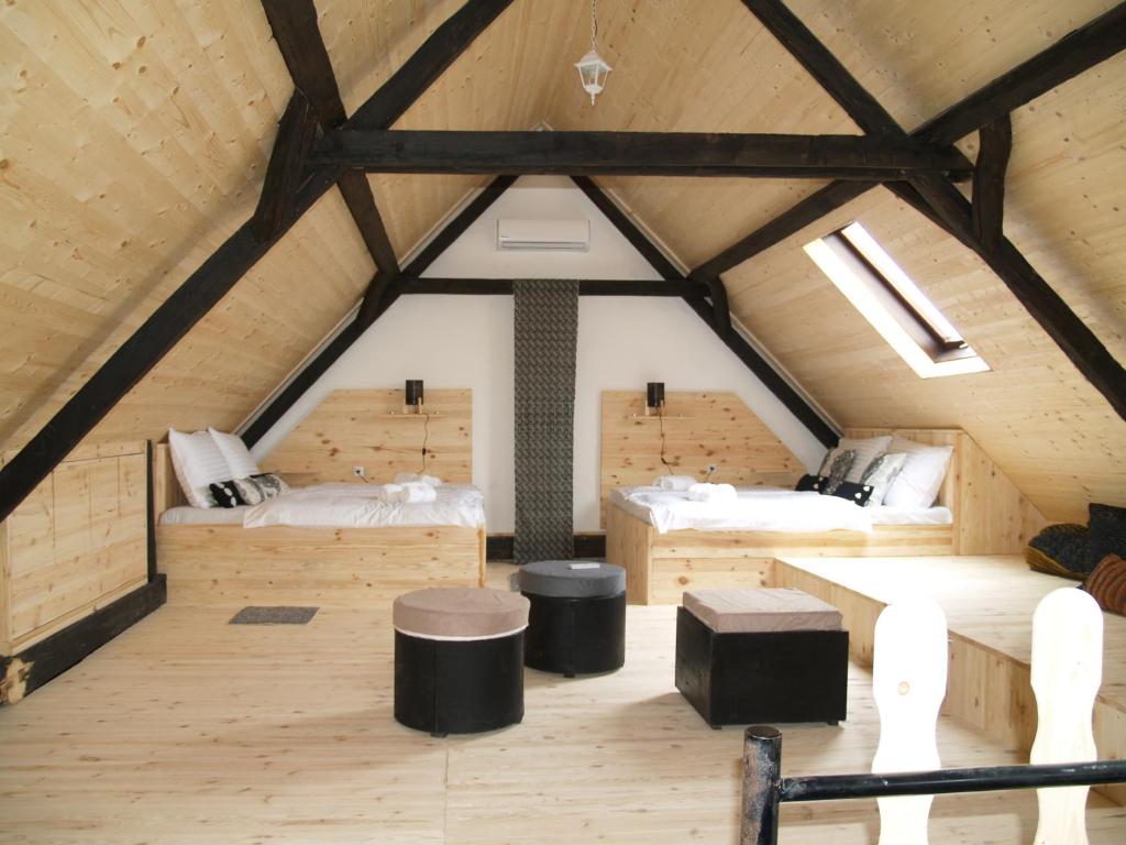 a room with two beds in a attic at Pannonia Terranova in Vardarac