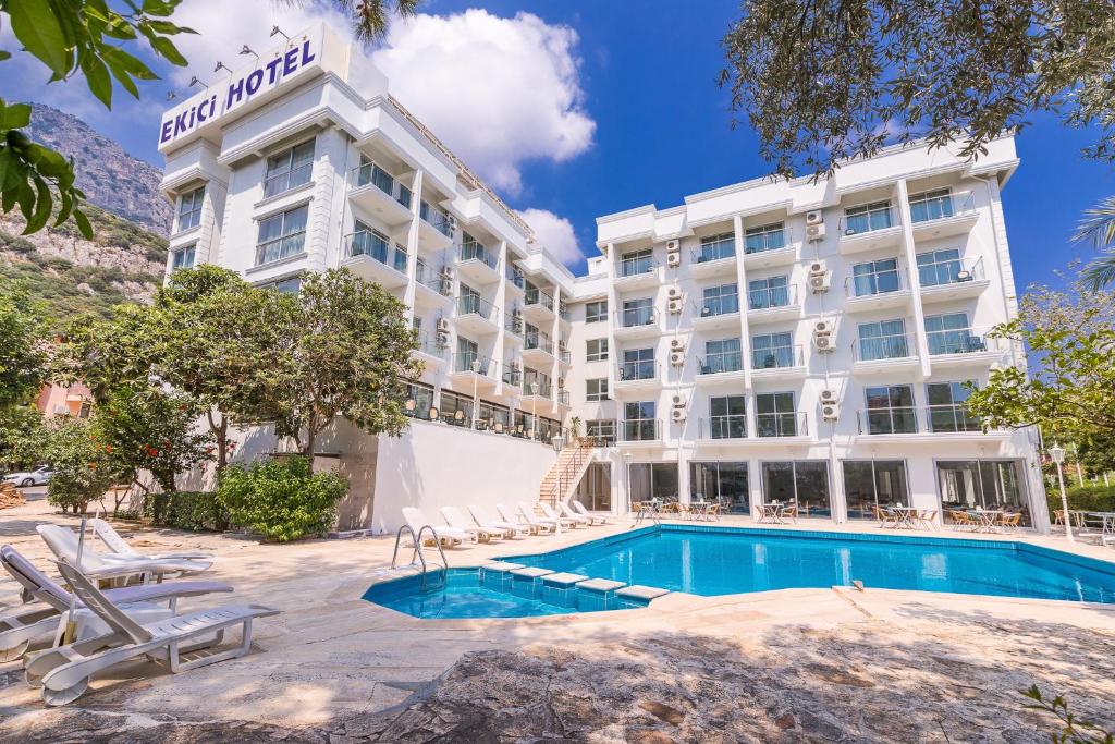 a hotel with a swimming pool and a resort at Ekici Hotel in Kaş