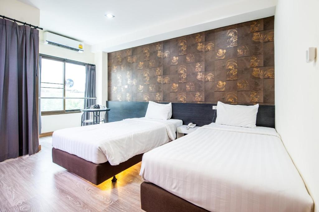Postel nebo postele na pokoji v ubytování Prajaktra City Hostel