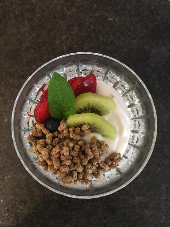 a bowl of fruit and nuts on a table at Darlington House Bed and Breakfast in Niagara-on-the-Lake
