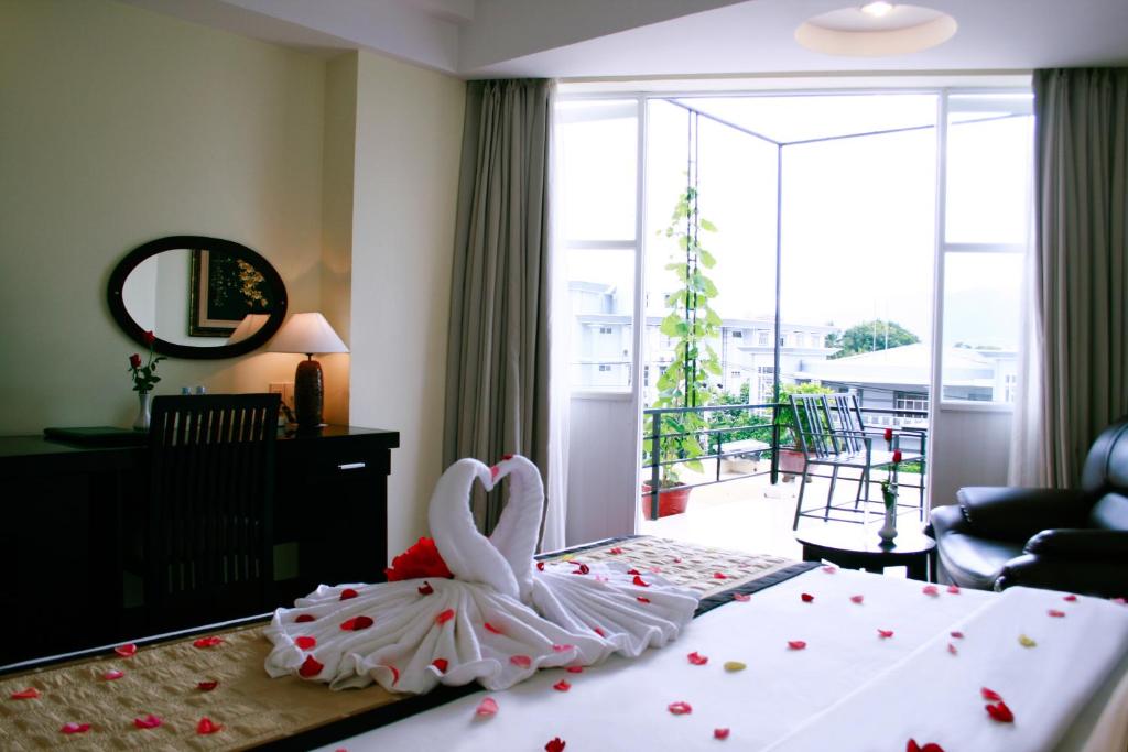 Postel nebo postele na pokoji v ubytování Angella Hotel