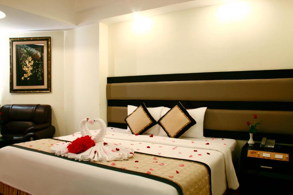 Postel nebo postele na pokoji v ubytování Angella Hotel