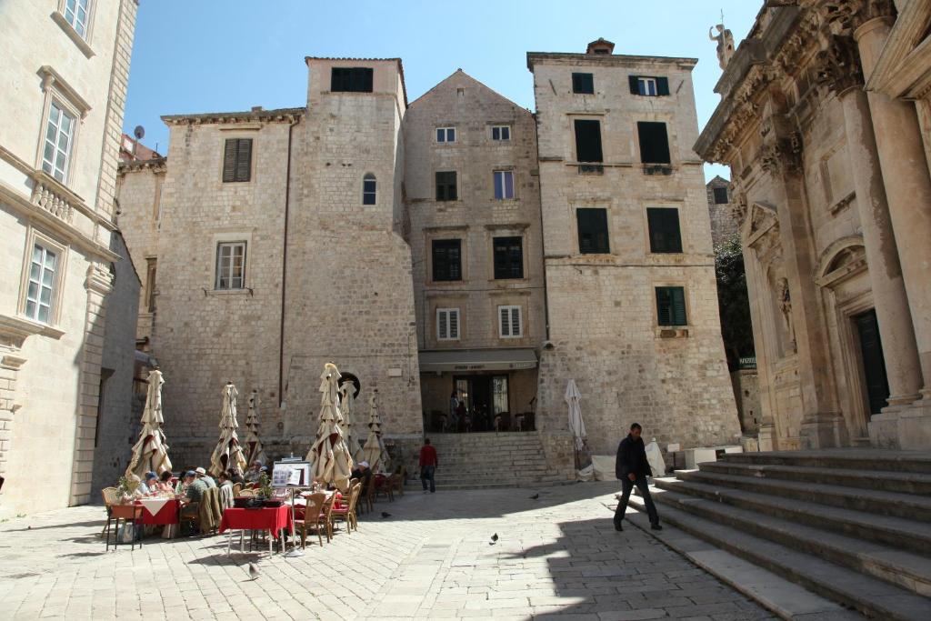 a man walking through a courtyard in a castle at Studio Esperanza Dubrovnik in Dubrovnik