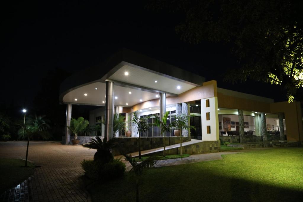 a house with a lit up facade at night at Twangale Resort & Spa in Lusaka