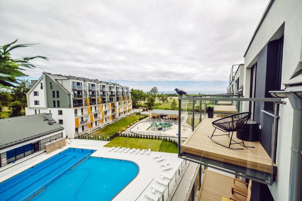 a balcony with a swimming pool on a building at Apartament Blue Point 406 PREMIUM in Kołobrzeg