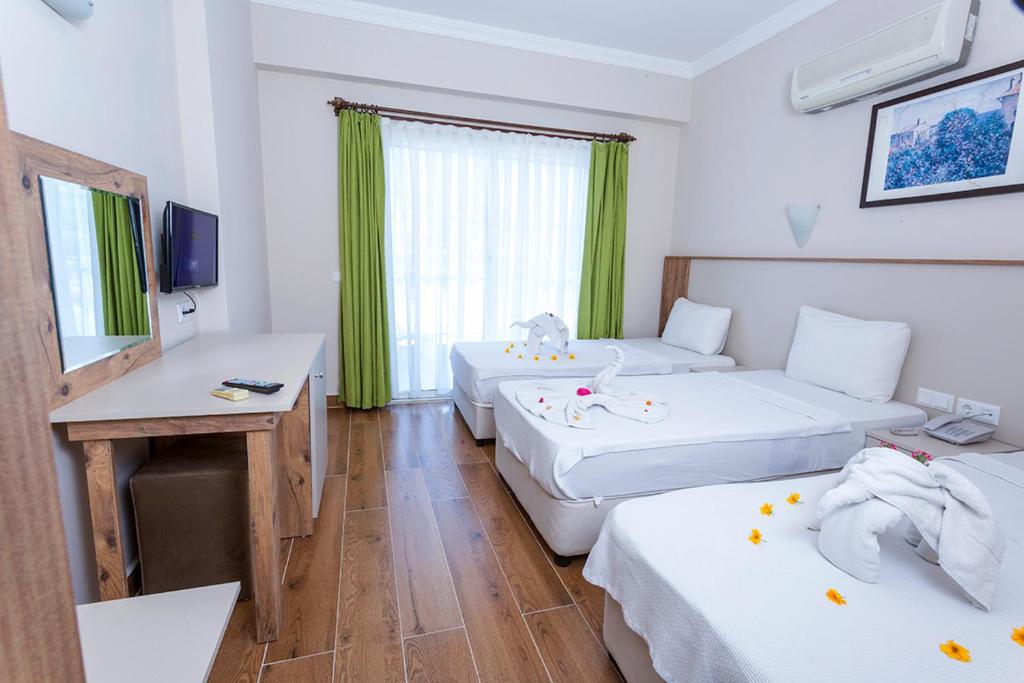 A bed or beds in a room at Rich Melissa Hotel