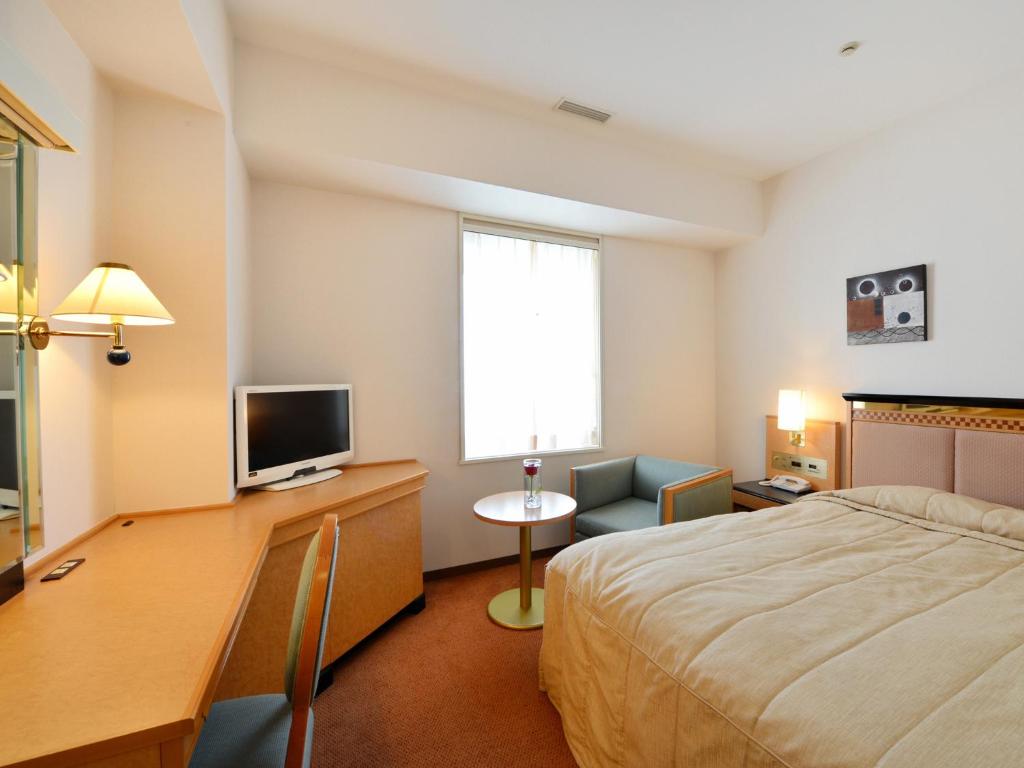 Postel nebo postele na pokoji v ubytování Hotel Crown Palais Kobe