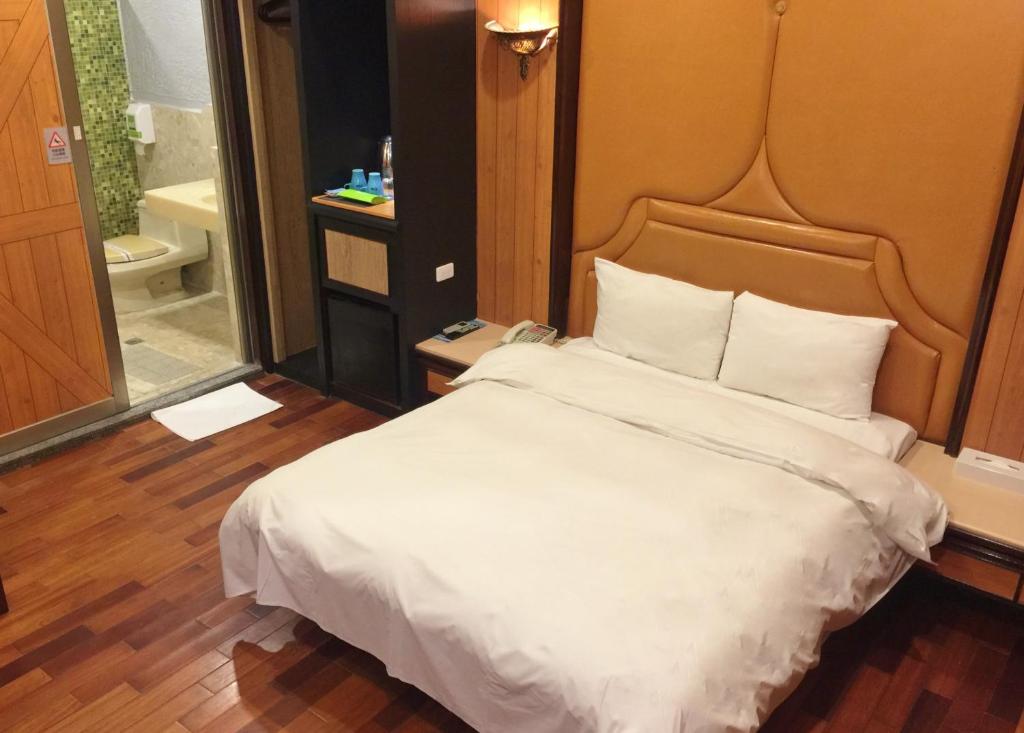 Postel nebo postele na pokoji v ubytování Guest Motel-Zhubei